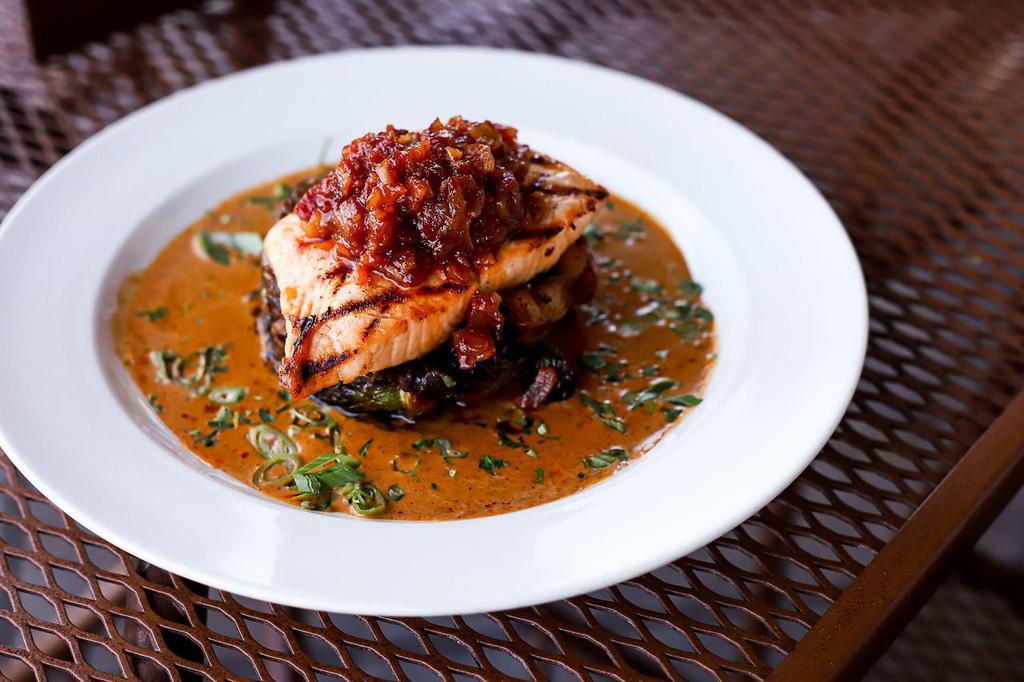 Grilled Salmon with Herb Cream · Brussels sprouts, applewood bacon, baby red potatoes, caramelized onion, herb cream, maple bacon jam.