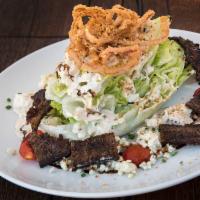 Wedge Salad · Hardwood smoked bacon, tomatoes, blue cheese crumbles, crispy cabbage, blue cheese dressing ...