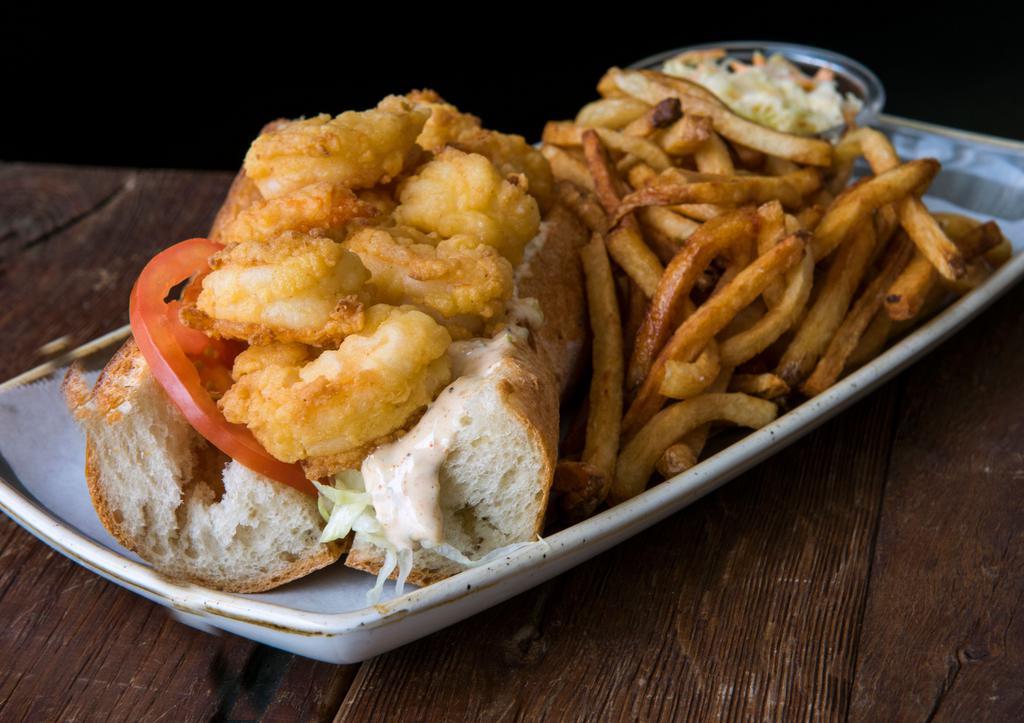 Fried Shrimp Po' Boy Sandwich · Shredded lettuce, tomato, pickle, roasted red peppers and spicy remoulade. Hand Cut French Fries, Cole Slaw