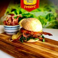 Mr. Pig sandwich · Slowed cooked sheered pork, classic green mix, sliced bacon, and provolone cheese, touched u...