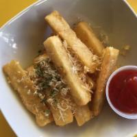 Yuca Garlic Fries · Fried yuca sticks topped with garlic, and sprinkled Parmesan cheese.