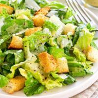 Caesar Salad · Fresh chopped Romaine lettuce tossed in Caesar dressing, topped with Parmesan cheese and hom...