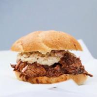 Pulled Pork Sandwich · Our pulled pork is placed in a kaiser roll. The addition of sauce, slaw and/or pickles are f...