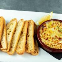 Famous Spicy Artichoke Dip · Vegetarian. Blend of artichokes, roasted red peppers, jalapeños and parmesan with crostini f...