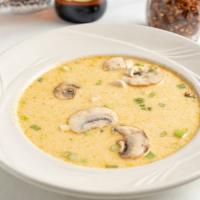 Tom Kha Spicy Coconut Soup · Spirited chicken coconut milk soup, seasoned with galangal, lime juice, chilies, and mushroo...