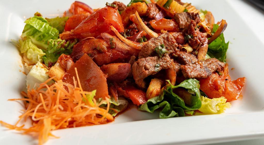 Fiery Grilled Beef Salad · Char-grilled strips of lean beef tossed with fresh vegetables, Phuket chili paste, balanced with lemon juice, and cilantro.