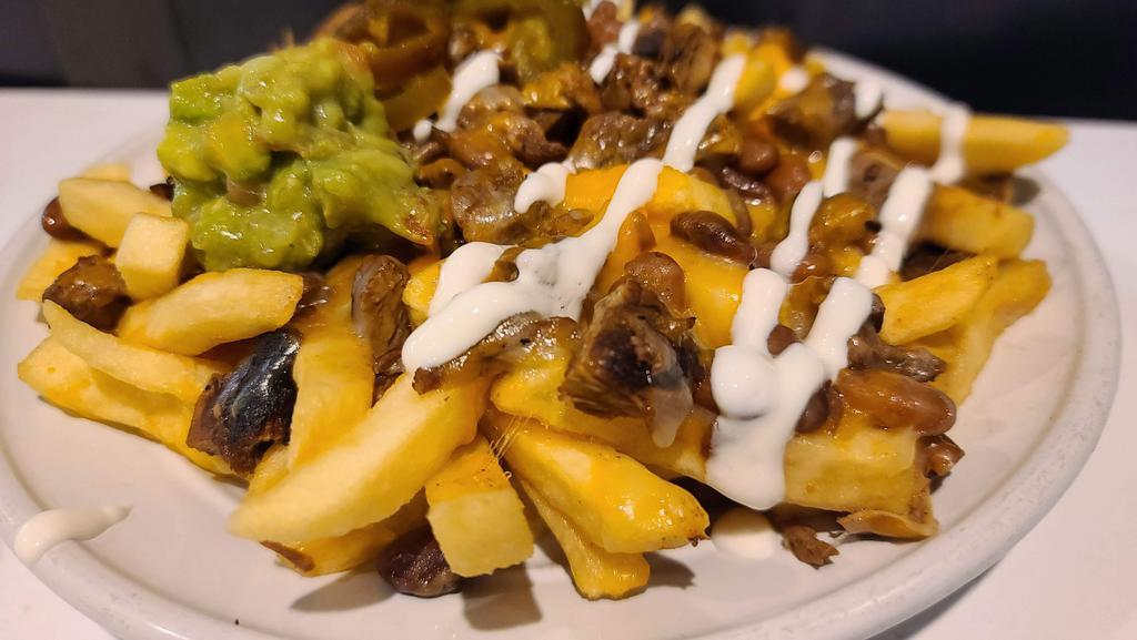 Papas (Asada Fries) · French fries, choice of meat, beans, jack and cheddar cheese, sour cream, guacamole and jalapenos.