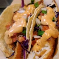 Fish Taco Plate · 3 corn tortilla tacos, red cabbage, chipotle sauce and pico de gallo. Served with Rice and P...