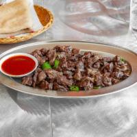 Weta Geba · Medium rare beef chunks cooked with fresh herbs and spices, onions and jalapeno peppers.
