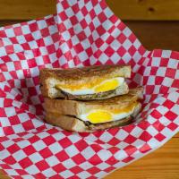 Bacon Apple Cheddar Egg Panini · hickory bacon . apple butter . fried egg . cheddar . pressed in butter toasted bread