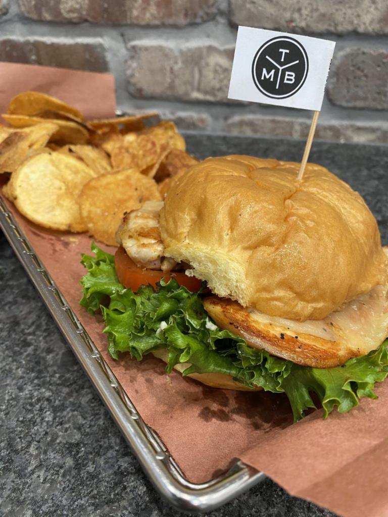 The Yard Bird Sandwich · Air-chilled, grilled chicken breast, white cheddar, lettuce, tomato, mayonnaise & mustard, on a sweet kolache bun.

Served with house-made chips.