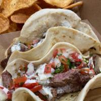 Beef Fajita Tacos · Topped with house queso and house pico de gallo.

Served with house-made chips.