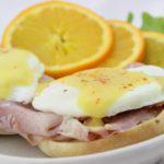 Traditional Benny · Smoked ham and two poached eggs* on a toasted English muffin covered in rich, creamy holland...