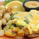 Open-Faced Smothered Croissant · Scrambled eggs mixed with spinach, diced ham and a blend of Monterey Jack and Cheddar cheeses all smothering a buttery croissant. Served with a side of creamy hollandaise.