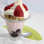 Yogurt Parfait · Strawberry low-fat yogurt layered with granola, blueberries and strawberries. Topped with whipped cream.