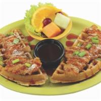 Chicken and Waffles · Breaded chicken tenders on a Belgian waffle, sprinkled with powdered sugar and chives drizzl...