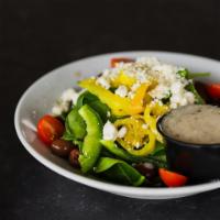 Greek Salad · Romaine lettuce and iceberg lettuce, spinach, feta, green peppers, Greek olives, banana pepp...