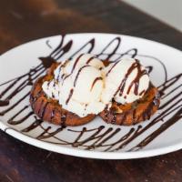 Deep Dish Cookie · Chocolate chip cookie baked in a pan, served warm topped with drizzled chocolate.
