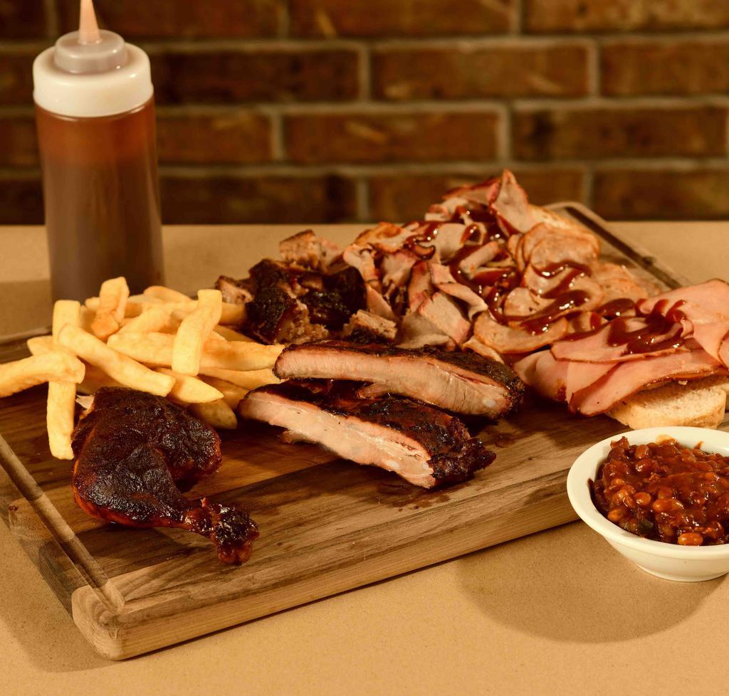 Variety Plate Specialty · Serves 2. Choice of 2  sliced beef, turkey, and ham plus sliced sausage, pork burnt
ends, 1/4 bone-in chicken, and a rib snack. Served over bread with a choice of 2 classic sides, pickle, and sauce.