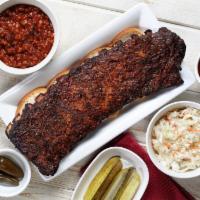 Rib Pack Specialty · Serves 2-3. Full slab served over bread with a pint of beans, a pint of slaw, peppers, pickl...