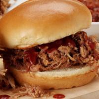 Pulled Pork Sandwich · Tender and juicy hickory-smoked pulled pork pilled high on a Roma bun.