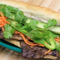 127 - Grilled Sesame Beef Hoagie · Grilled sesame beef, butter, sauteed scallions, house sauce, pickled carrots, cucumber, jala...