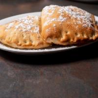 Nutella Calzones · 3 pieces. Delicious donuts filled with Nutella and topped with powdered sugar.