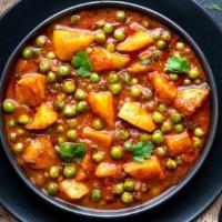 Aloo Matar Curry · Vegan & Vegetarian- Cooked potatoes and peas sautéed in tomato onion sauce.