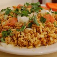 Bhel Puri · Vegan & Vegetarian- Puffed rice mixed with potatoes, onions and tangy tamarind sauce.