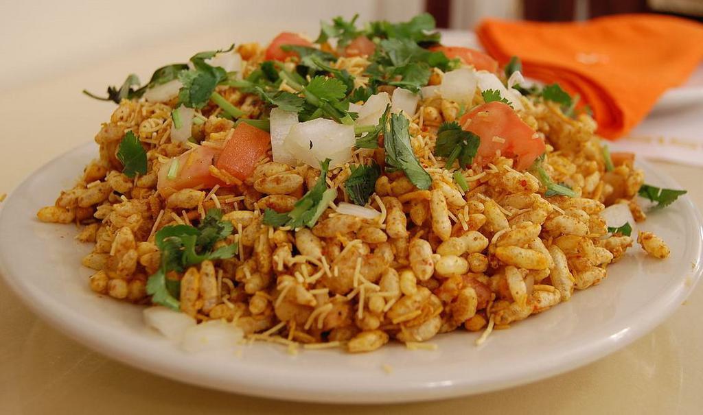 Bhel Puri · Vegan & Vegetarian- Puffed rice mixed with potatoes, onions and tangy tamarind sauce.