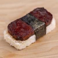 Spam Musubi · Combo of rice, seared spam glazed in teriyaki sauce wrapped in dried seaweed.