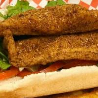 Catfish Sandwich · 2 filleted catfish fried til golden & cajun fries. Comes with lettuce, tomatoes, pickles, ma...