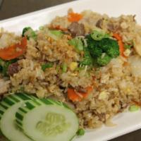 19. Thai Fried Rice · Stir fried Thai jasmine rice with onions, broccoli, peas and carrots, tomatoes and eggs.