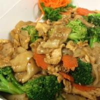 26. Pad See Ew Noodles · Stir fried wide rice noodles with sweet soy sauce, broccoli, Chinese broccoli, carrots and e...