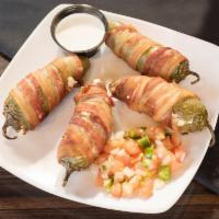 Fresh Jalapeno Poppers · 6 half jalapenos stuffed with our signature cheese blend and wrapped in applewood-smoked bac...