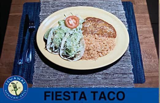 Fiesta Taco Plate · Corn tortilla filled with your choice of meat, lettuce guacamole, and cheese. Includes rice and beans.

