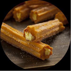 Creme-Filled Churros · The perfect end to your meal. Three light & flaky, golden, creme-filled Churros sprinkled with the irresistible sweetness of cinnamon & sugar.