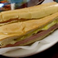 Famous El Cubano Sandwich · Ham, pork, Swiss cheese, pickles and mustard nicely pressed on Cuban bread.