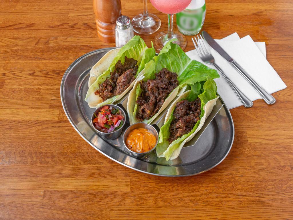 Korean BBQ Lettuce Wrap · Marinated beef ribeye with soy sauce, agave, maple syrup, scallions and corn tortilla.