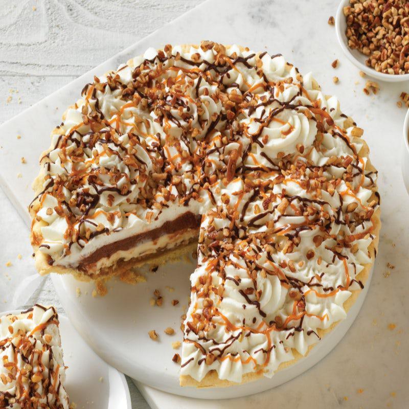Whole Caramel Pecan Silk Supreme Pie · A rich and decadent pie featuring a layer of our classic French Silk, a creamy supreme filling, and a layer of caramel and Texas pecans. Topped with real whipped cream and drizzled with chocolate sauce, caramel and pecans.