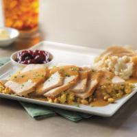 Slow-Roasted Turkey · Hand-carved and served with cornbread stuffing, mashed potatoes and turkey gravy, and cranbe...