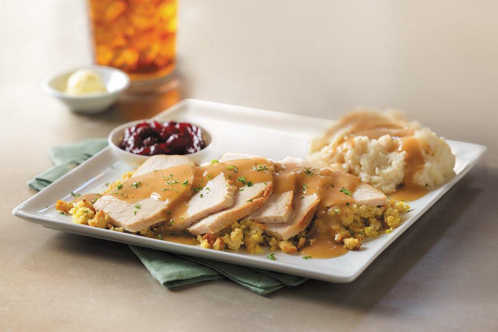 Slow-Roasted Turkey · Hand-carved and served with cornbread stuffing, mashed potatoes and turkey gravy, and cranberry sauce. (Serves 4 - 6)