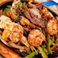 Salsas Fajitas  · A combination of shrimp, chicken, and steak. Fajitas are cooked with tomatoes, onions, and b...