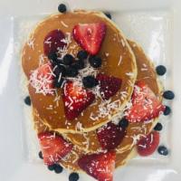 Blueberry and Coconut Pancakes · Our buttermilk baked with blueberries topped with strawberries and coconut.