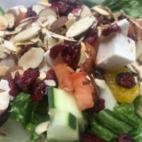 French Salad · Garden mixed green with tomatoes, cucumbers, fresh mozzarella, dried cranberries, sliced Man...