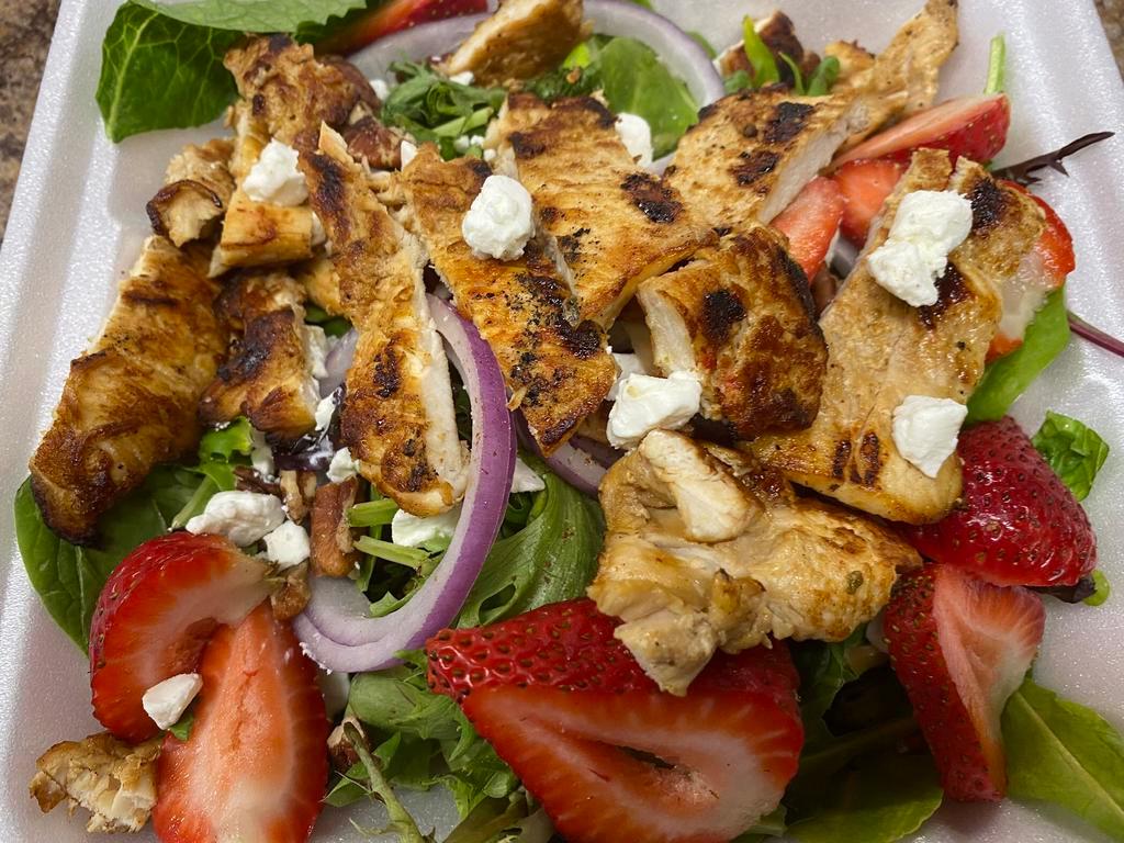 Strawberry Pecan Salad · Grilled chicken, mixed baby greens, sliced fresh strawberries, goat cheese, sliced onions, and glazed pecan served, balsamic strawberry vinaigrette.