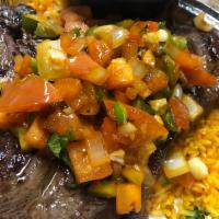 Carne Asada · 18 oz. marinated Porterhouse steak with sauteed onion, tomatoes, peppers & cilantro, served ...