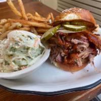 BBQ Pulled Pork Sandwich  · bbq smoked pork, pickles, white onion, bbq sauce, coleslaw served with fries or salad 
