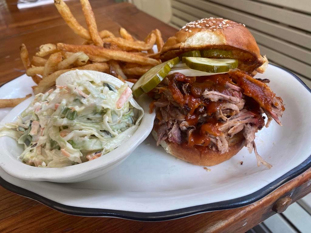 BBQ Pulled Pork Sandwich  · bbq smoked pork, pickles, white onion, bbq sauce, coleslaw served with fries or salad 