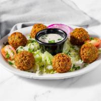 Falafel · Our famous fava bean patties, topped with tahini sauce.